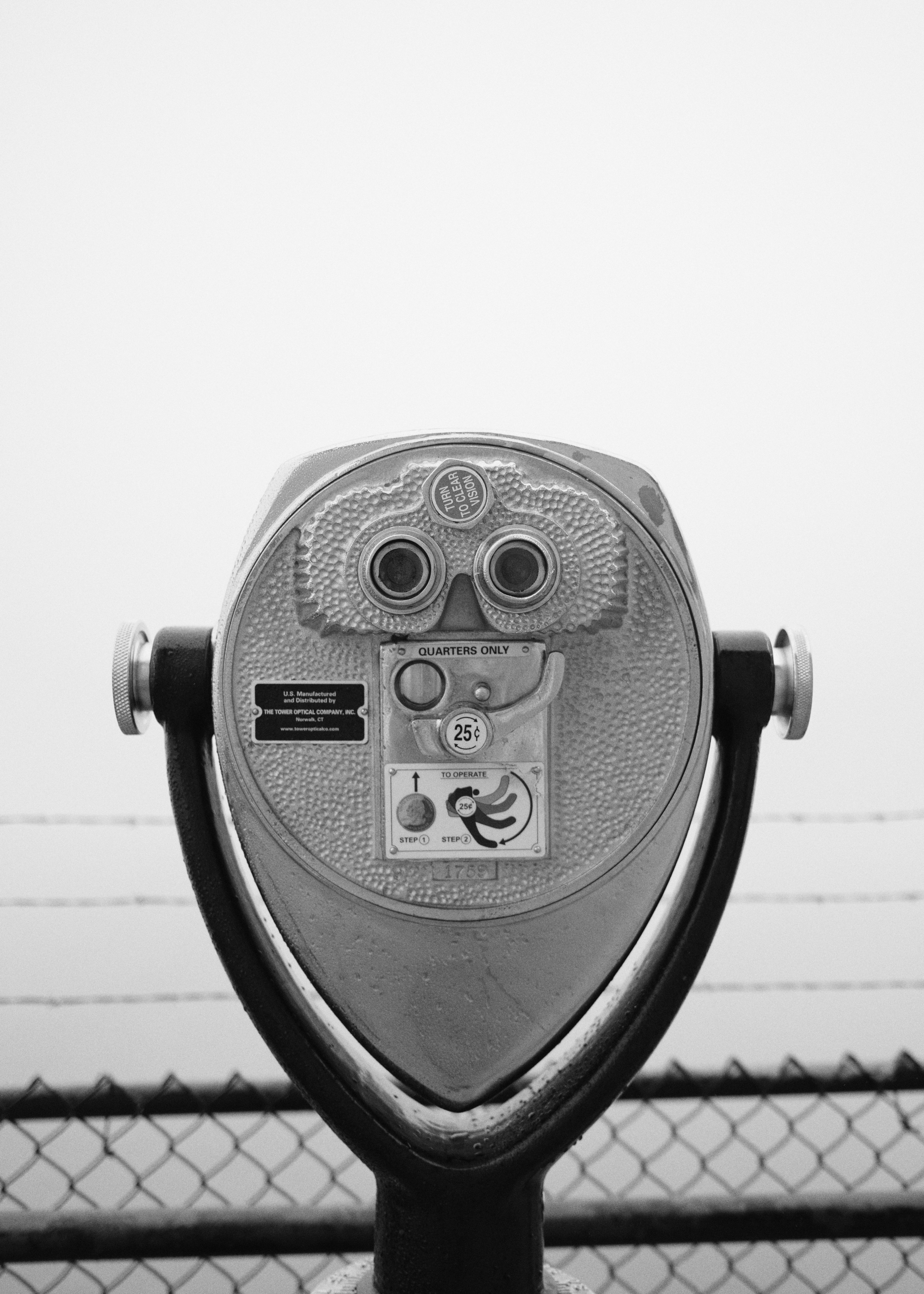 gray coin operated binoculars on white background